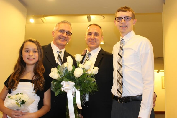 Paper Mill Playhouse Artistic Director Mark S. Hoebee (second from left) with husband Larry Elardo at their wedding, with children Ashley and Stephen.