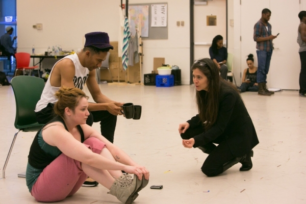 Cocreator Griffin Matthews, who also stars in Witness Uganda at A.R.T., works through a scene with actress Emma Hunton and director Diane Paulus during rehearsal. 