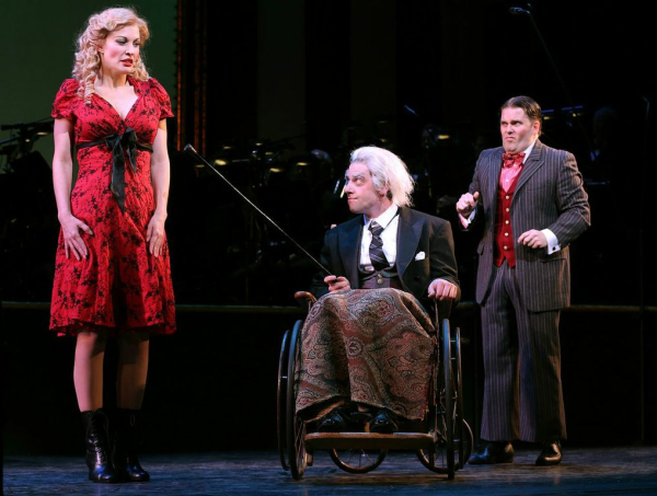 Belle Schlumpfert (Rachel York) asks miserly banker Amos Pinchley (Christian Borle) to dig "Deep Down Inside" for his hidden niceness. His son Junior (Robert Creighton) looks on incredulously in the Encores! production of Little Me at New York City Center.