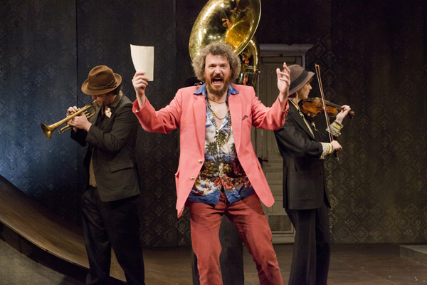 Sir Toby Belch (James Sugg) is flanked by a Balkan brass band in Pig Iron Theatre Company's production of Twelfth Night at Abrons Arts Center.