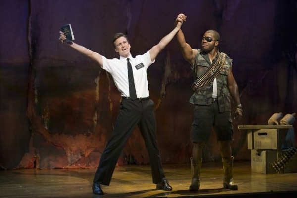 Gavin Creel (left) is a WhatsOnStage Award winner for his performance as Elder Price in the London production of The Book of Mormon. (He stands beside Derrick Williams as a Ugandan warlord.)