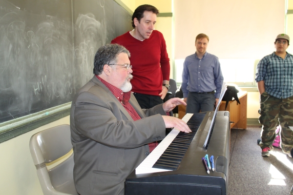 Cabaniss (right) stands beside Herrmann at the piano during a rehearsal for The Homework Machine at Boston Children&#39;s Theatre.