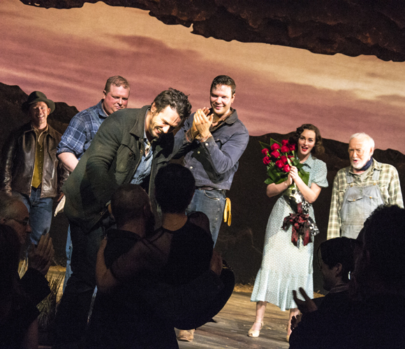 As the cast members of Of Mice and Men look on, Chris O&#39;Dowd lifts director Anna D. Shapiro onto the stage with the assistance of James Franco.
