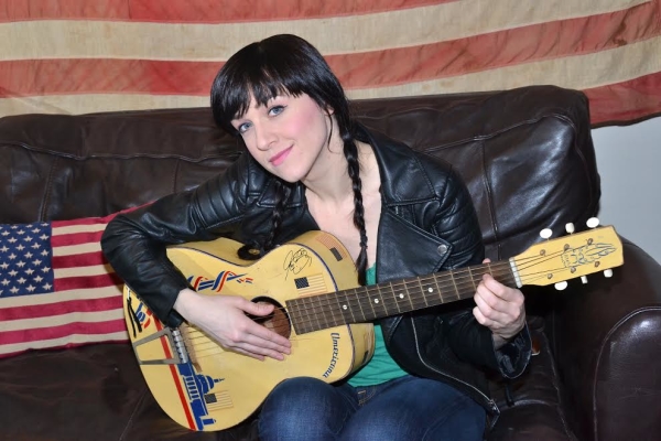 Lena Hall strums her guitar in the Belasco dressing room where she goes from punky rocker princess to moody rocker prince.