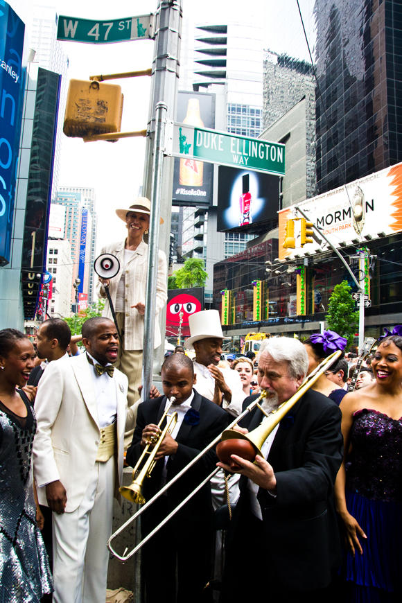 (from left) Dormeshia Sumbry-Edwards, Dule Hill, Mercedes Ellington, and band members from After Midnight jam in Times Square.