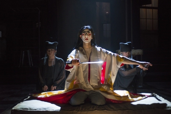 Sean Fortunato as Rene Gallimard, flanked by Greek chorus members Sarah Lo and Aurora Adachi Winter in M. Butterfly, directed by Charles Newell, at Chicago&#39;s Court Theatre. 