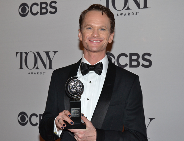 Neil Patrick Harris smiles slyly while showing off his Tony.