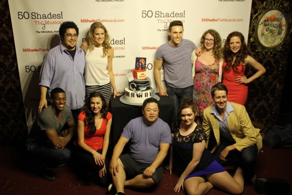 The cast of 50 Shades! The Musical poses with the show&#39;s celebratory cake.