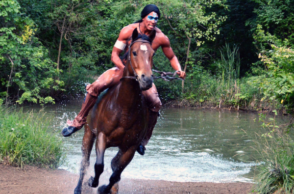 Chris Manns rides a horse through a pool of water in a dramatic scene from Allan W. Eckert&#39;s Tecumseh! at the Sugarloaf Mountain Amphitheatre.
