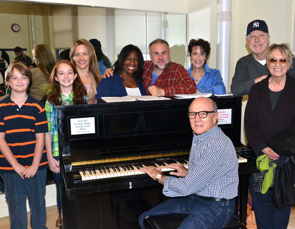 The cast of A Christmas Memory with composer Larry Grossman (at the piano), lyricist Carol Hall and book writer Duane Poole (standing, right).