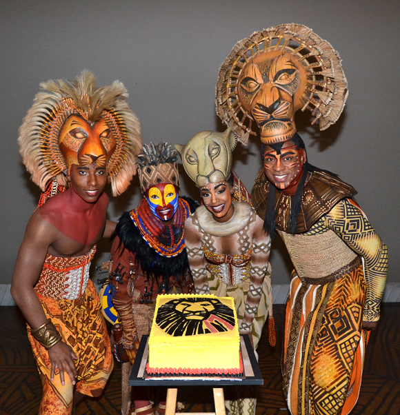 The Lion King stars Aaron Nelson (Simba), Nteliseng Nkhela (Rafiki), Chantel Riley (Nala), and Alton Fitzgerald White (Mufasa) gather around the the show&#39;s 17th birthday cake.