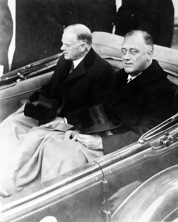 Herbert Hoover rides in a car with Franklin D. Roosevelt during the latter&#39;s inauguration on March 4, 1933.
