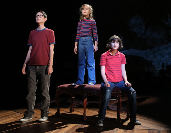 Beth Malone, Sydney Lucas, and Alexandra Socha as Alison Bechdel at various ages in a scene from the Public Theater production of Fun Home, directed by Sam Gold.
