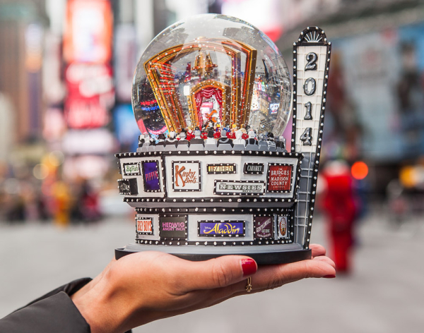 The 2014 Broadway Cares snow globe features dozens of Broadway logos.