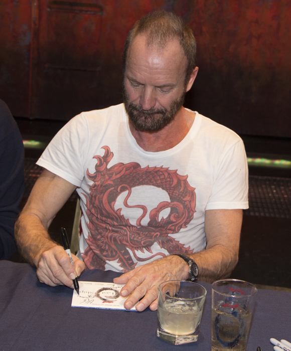 Sting puts his signature on a copy of the Last Ship cast recording.