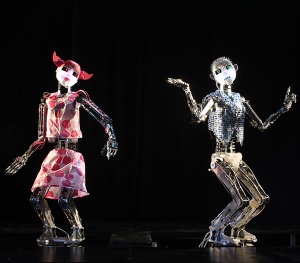 Two RoboThespians perform in costume.